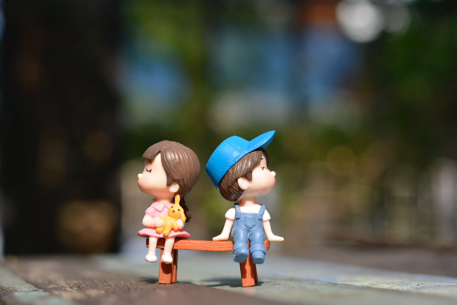 boy and girl sitting on bench toy
Photo by Suparada Intharoek on Pexels.com