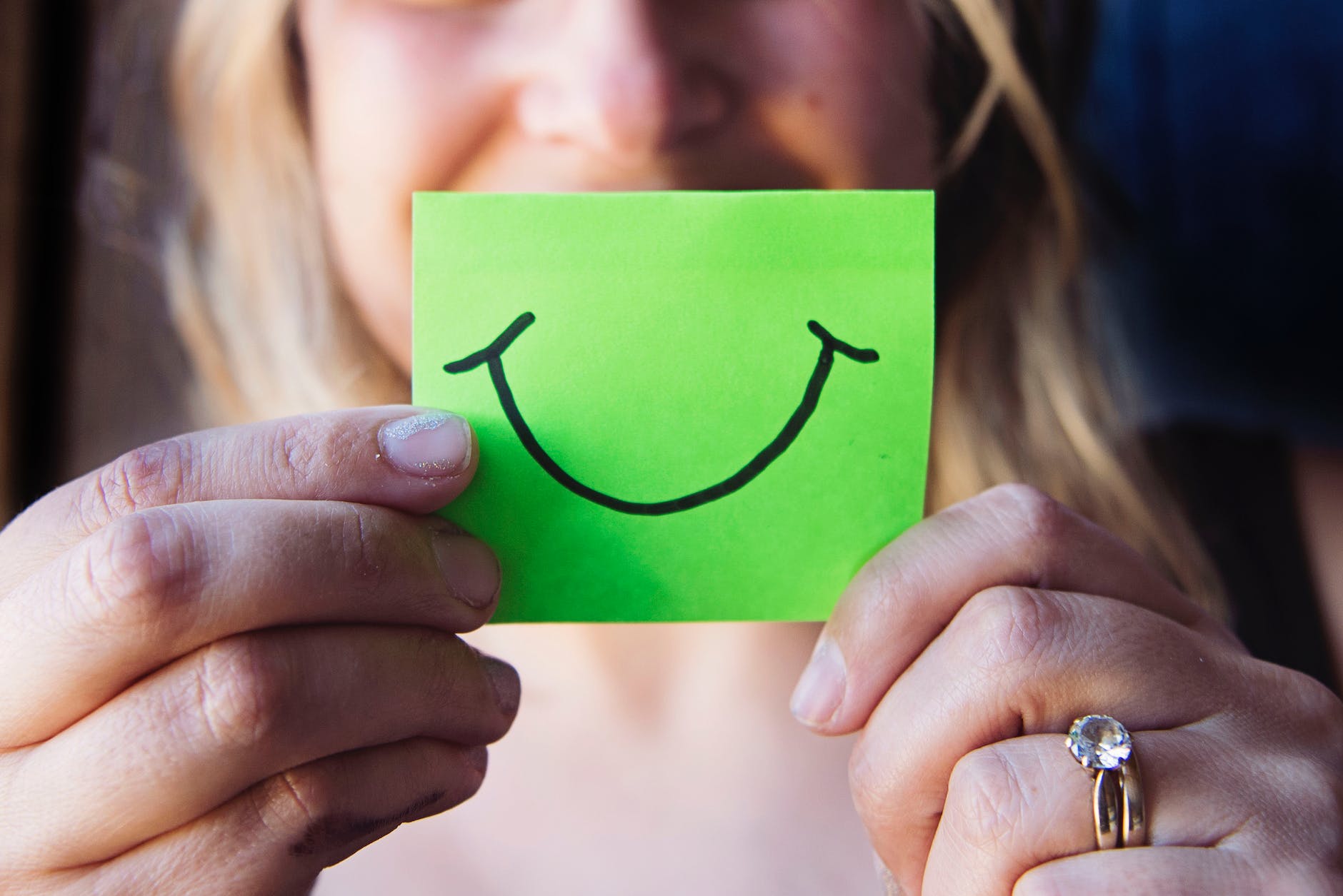 photo of woman holding a green paper Photo by Kat Smith on Pexels.com